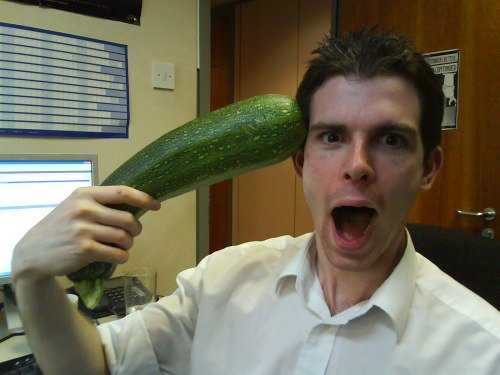 Camera Phone shot of Mike shooting himself with an oversized Courgette